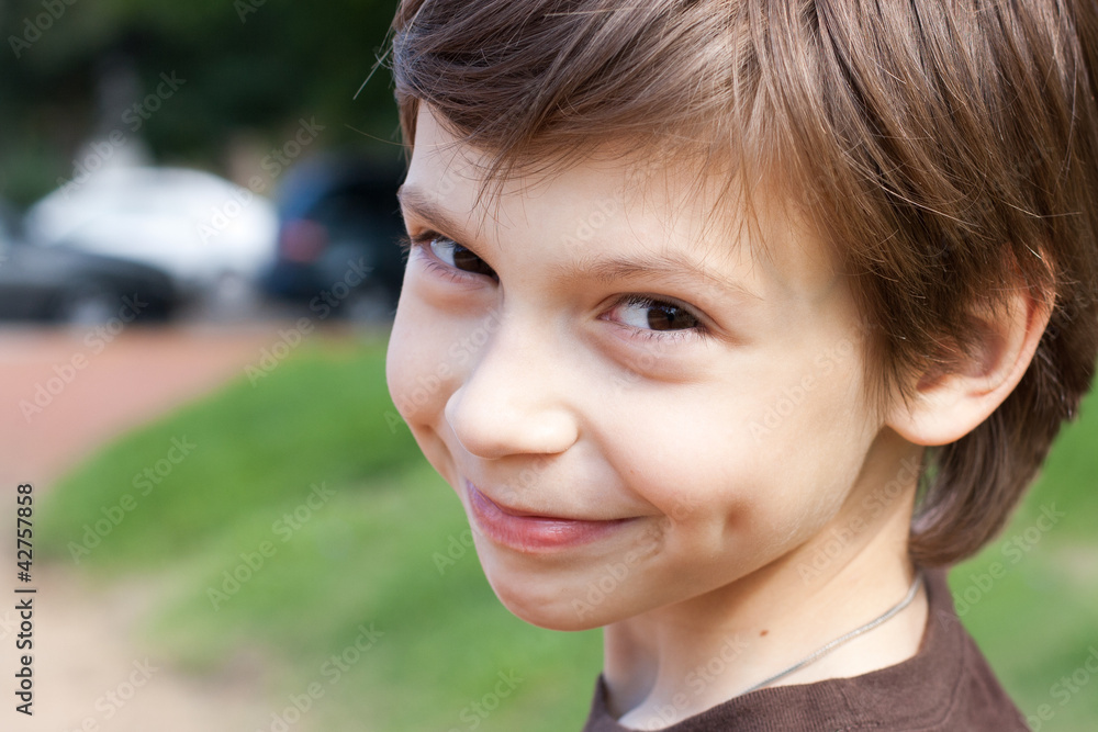 close up portrait of a smiling little boy in the park close up portrait of a smiling little boy in the park