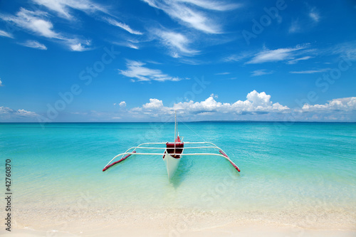 White boat on a tropical beach