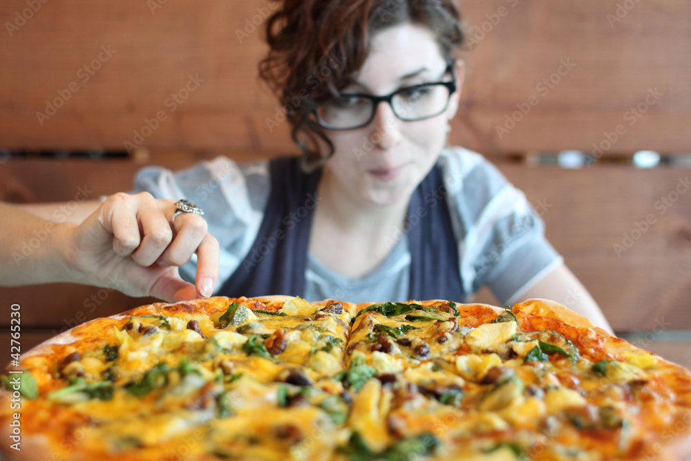 Pretty woman with vegetarian pizza.