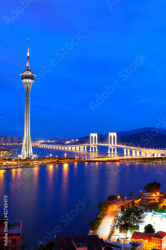 Cityscape in night with famous travel tower near river in Macao,