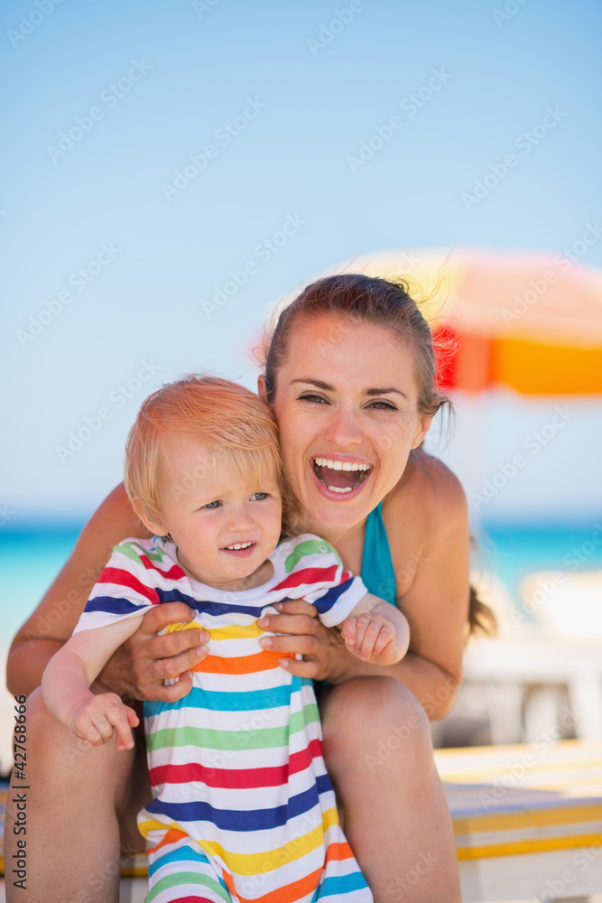Portrait of happy mother and baby on beach Portrait of happy mother and baby on beach