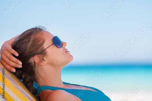 Relaxed woman laying on beach