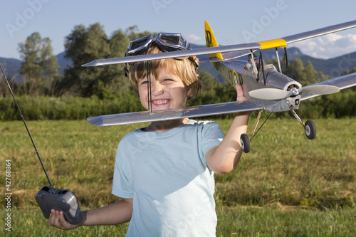 Smiling happy young boy and his RC plane