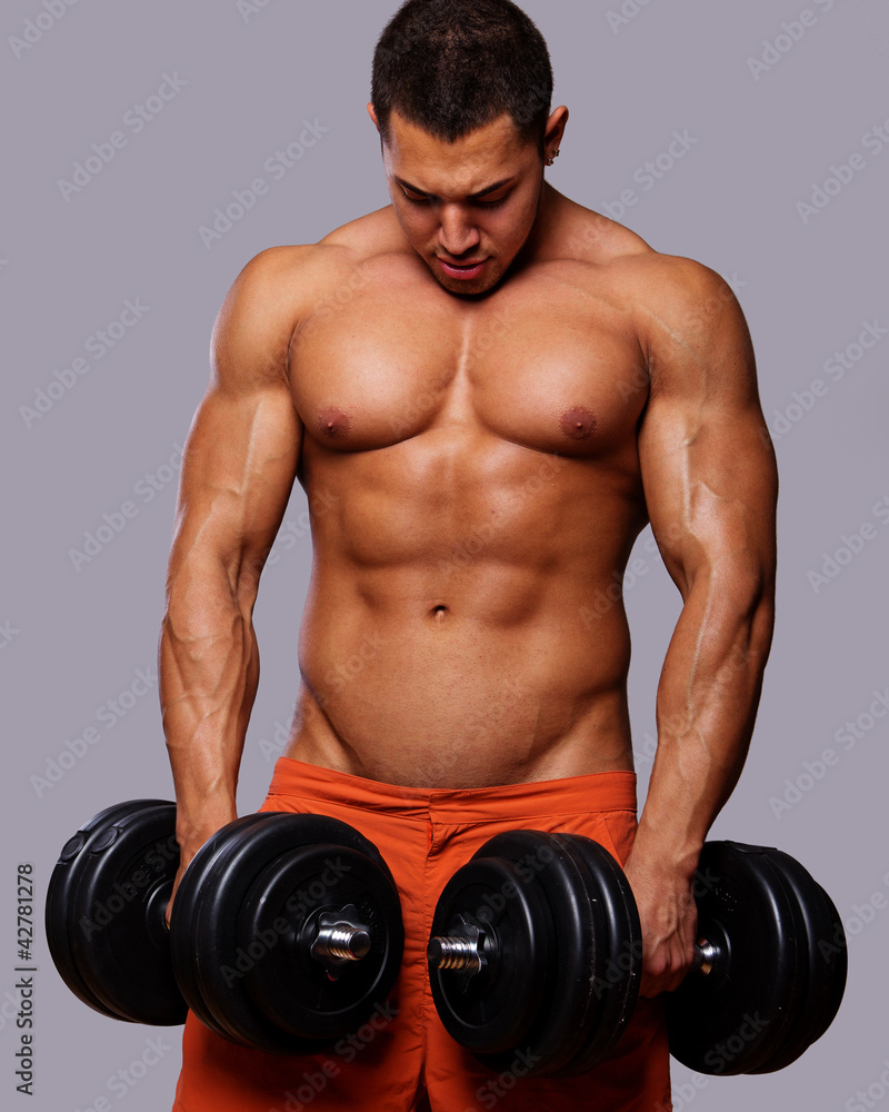 Portrait of young man lifting weights Portrait of young man lifting weights