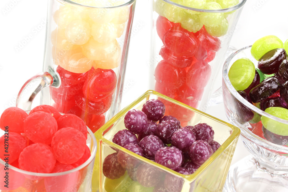Color candies in glasses isolated on white Color candies in glasses isolated on white