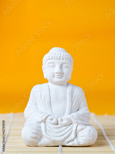Buddha statue on bamboo mat