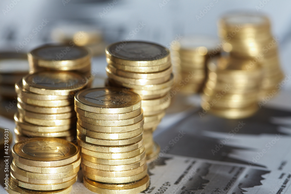 Business diagram on financial report with coins Business diagram on financial report with coins