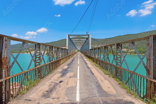 road and steel bridge over reservoir