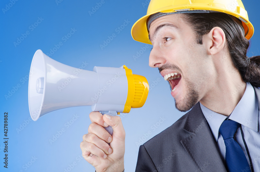 Fototapeta premium Construction worker shouting via loudspeaker