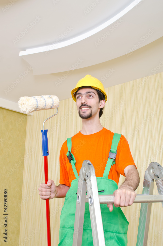 Painter worker during painting job Painter worker during painting job