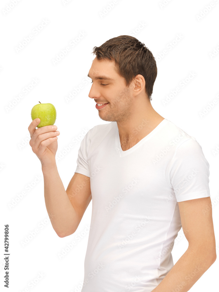 man in white shirt with green apple man in white shirt with green apple