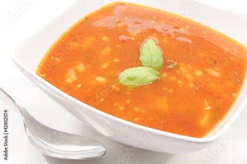 tomato soup with basil leaves