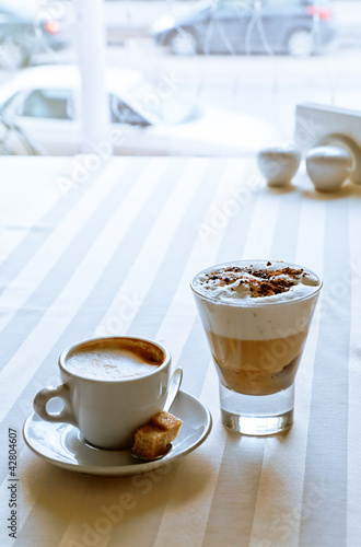 Fototapeta Naklejka Na Ścianę i Meble -  Appetizing coffee with sugar on a table in modern cafe