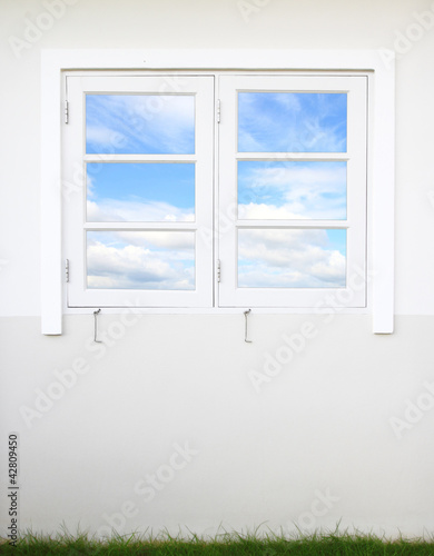 white window and wall with sky