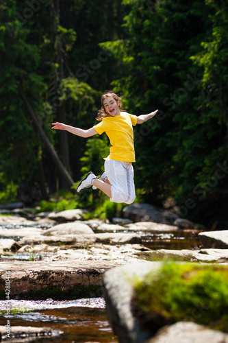 Girl jumping  running against blue sky