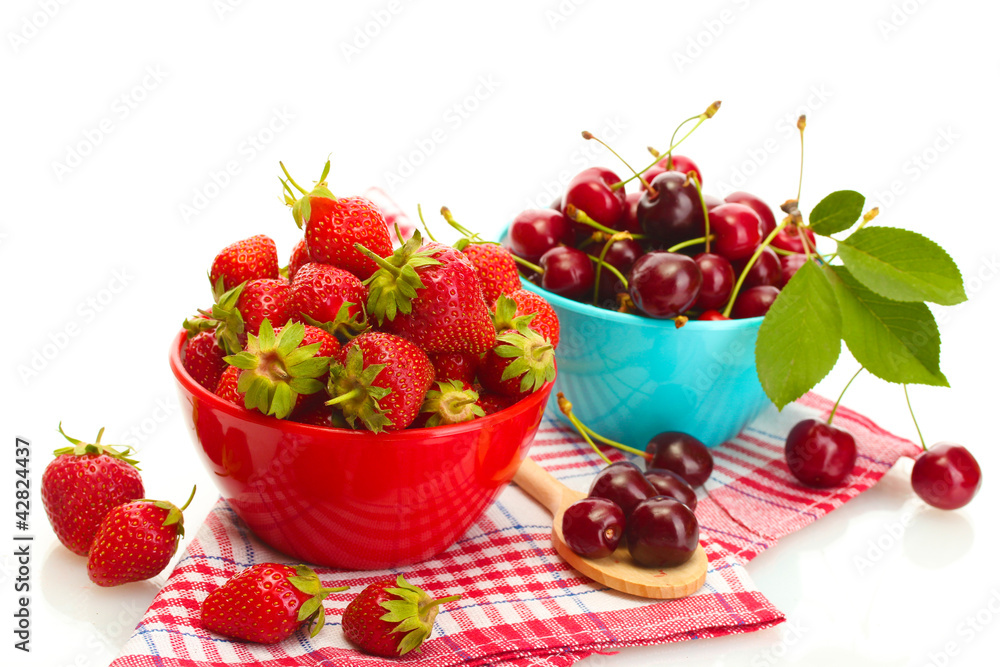 Ripe strawberries and cherry berries in bowls isolated on white Ripe strawberries and cherry berries in bowls isolated on white