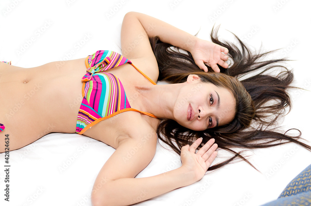 Obraz premium Attractive Asian woman lying down in bed