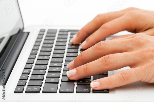 Extreme close up of hands on keyboard.