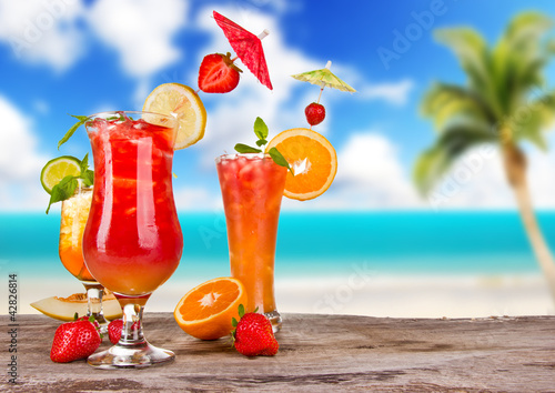 Summer cocktails with blur beach on background