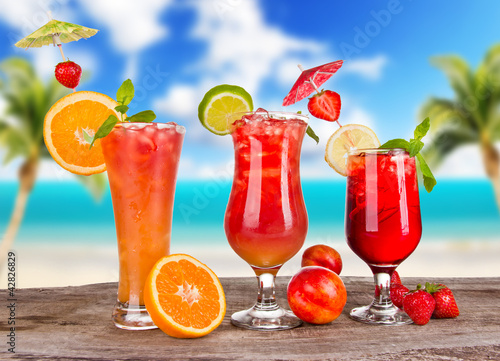 Summer cocktails with blur beach on background
