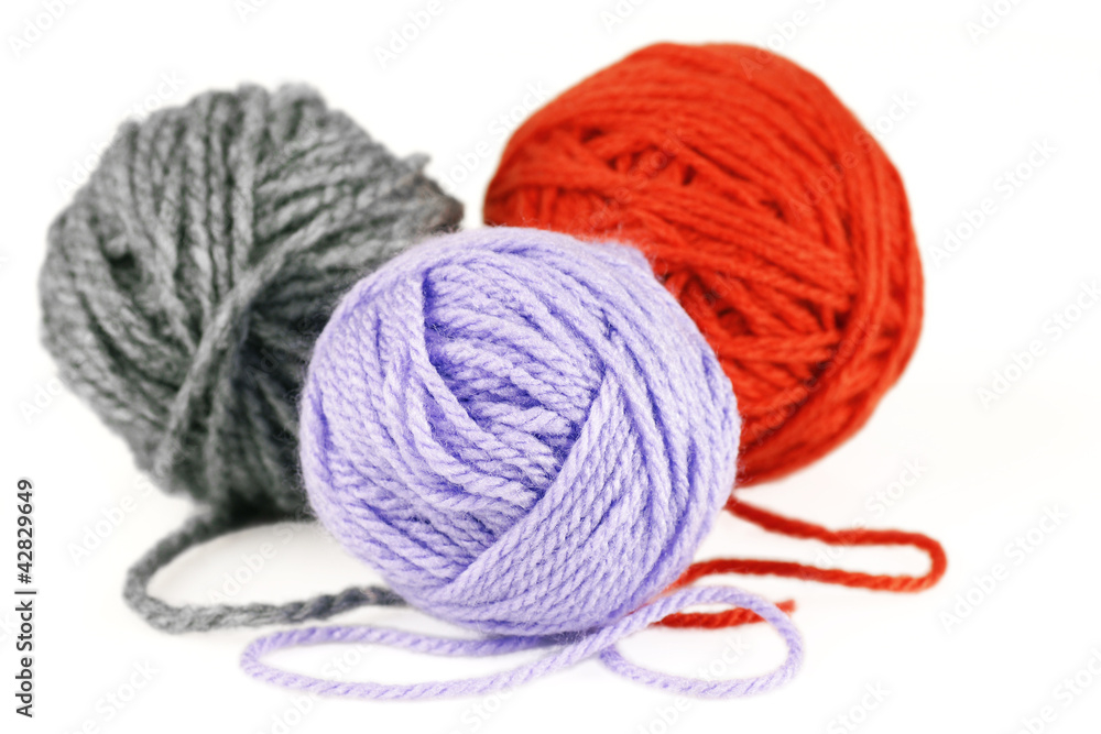 Balls of purple, orange and grey yarn or wool Balls of purple, orange and grey yarn or wool