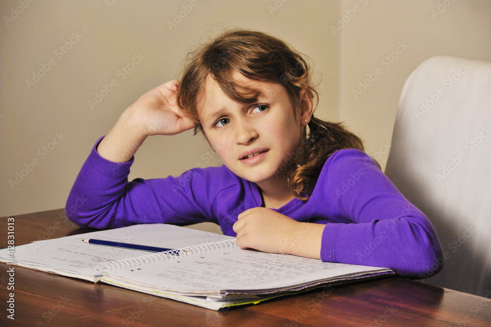 a young girl a troubled doing her homework a young girl a troubled doing her homework