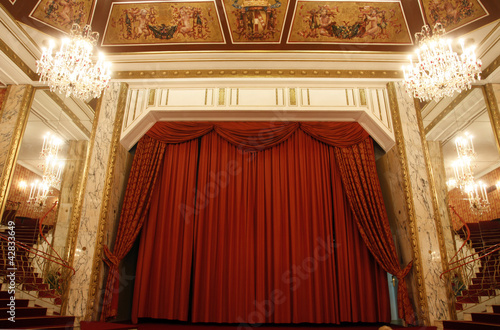 Old theater stage and red curtain