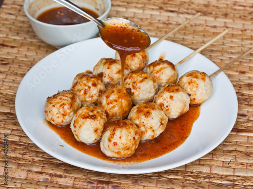 Roasted pork ball, pouring with sweet spicy sauce