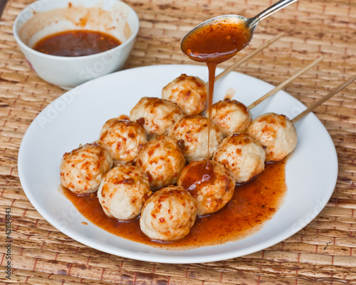 Roasted pork ball, pouring with sweet spicy sauce