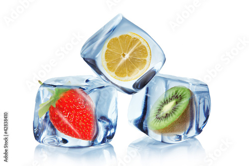 Fruit in ice cubes over white