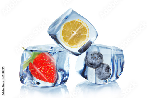 Fruit in ice cubes over white