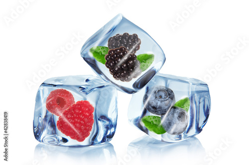 Fruit in ice cubes over white