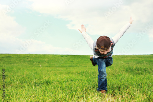 Young boy playing in a green grassy field