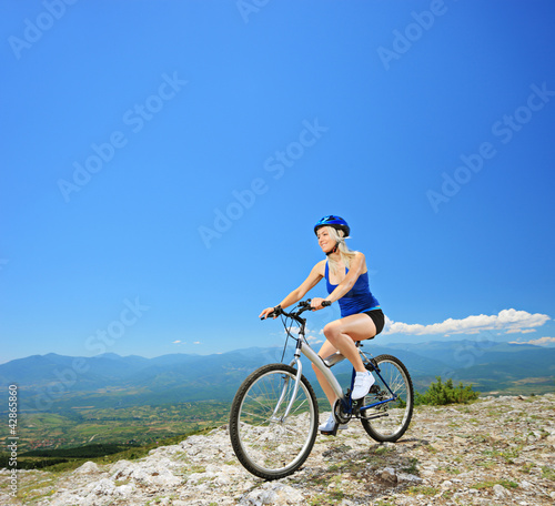 A female biker biking a mountain bike