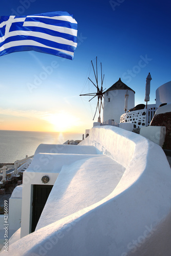 Santorini with windmill and flag of Greece