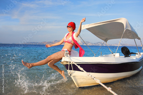Happy Woman on the boat during summer time