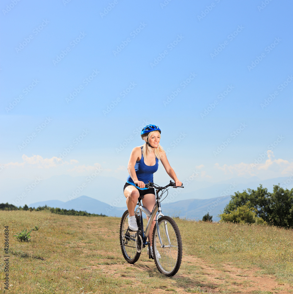 A female biker riding a mountain bike