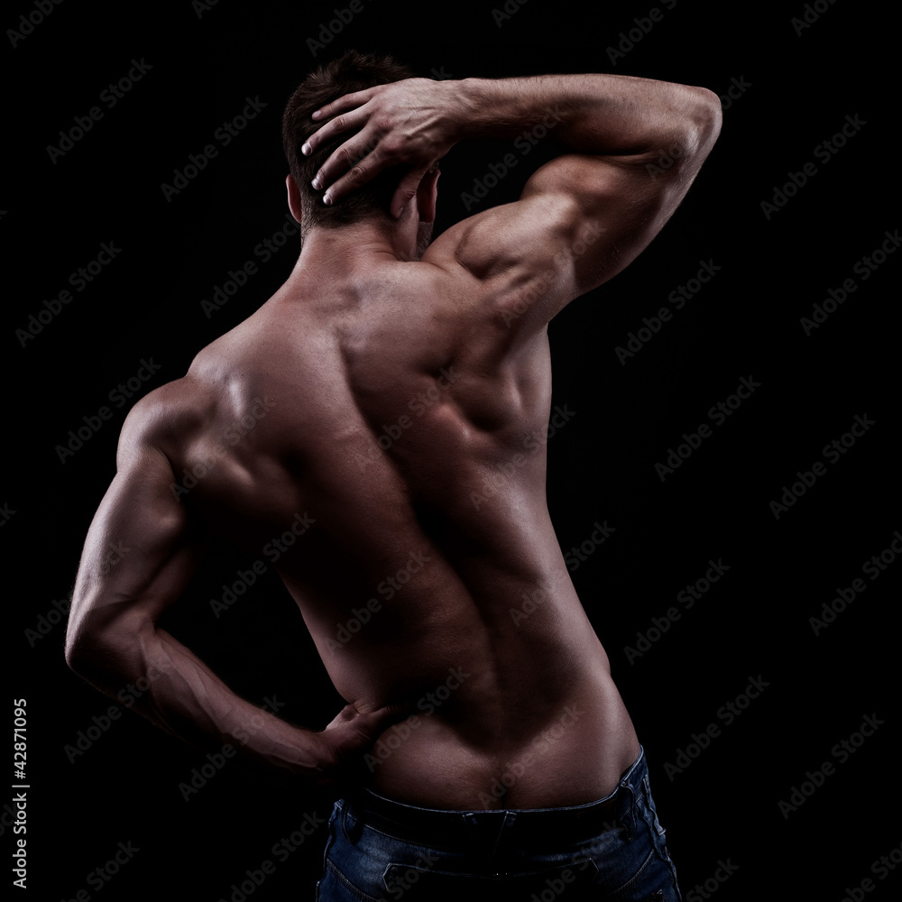strong athletic man on dark background