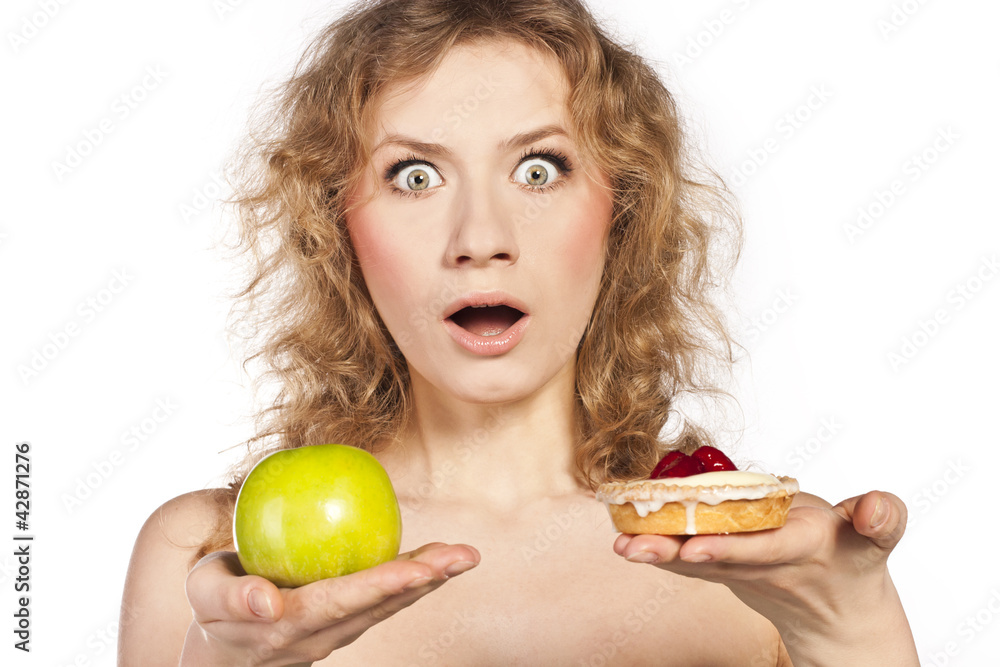 Beautiful blonde choosing, between an apple and a cake Beautiful blonde choosing, between an apple and a cake