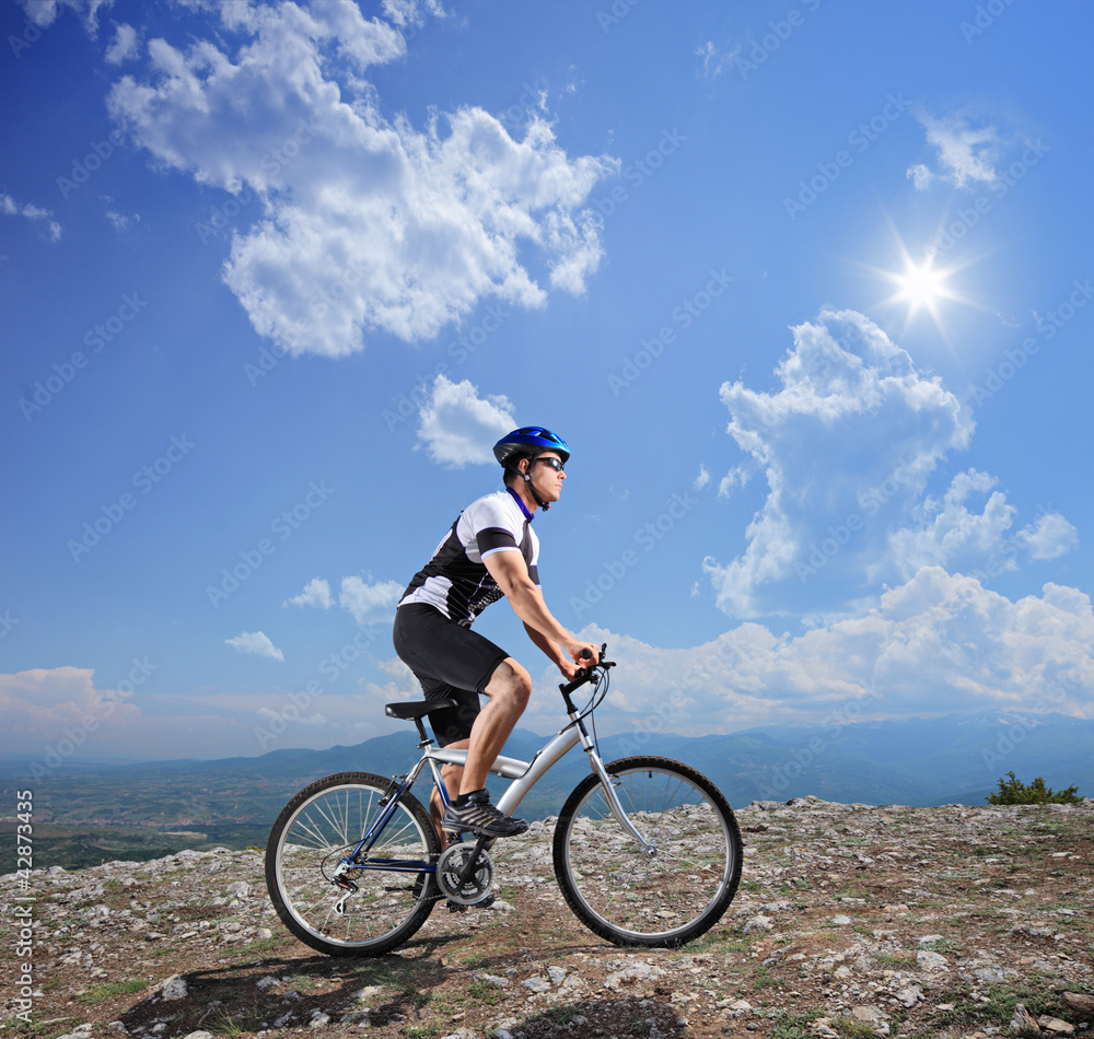 A young biker biking a mountain bike A young biker biking a mountain bike