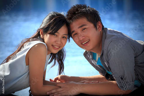 couples of asian man and woman at water pool