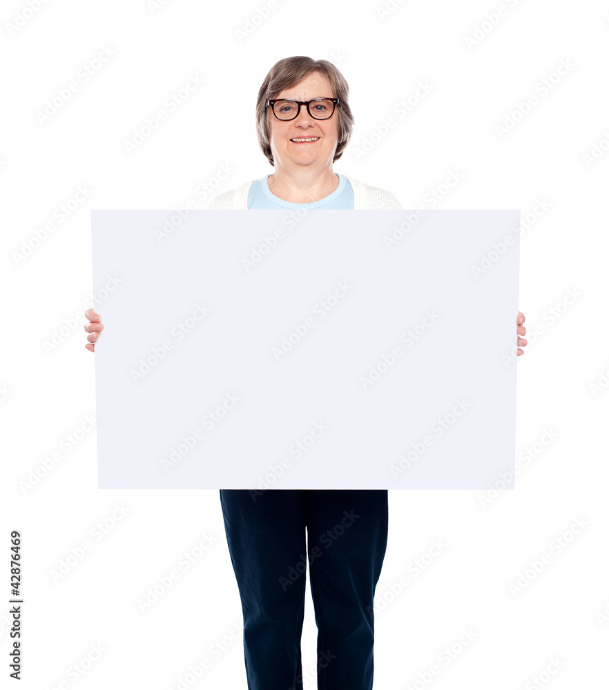 Aged woman displaying blank poster Aged woman displaying blank poster