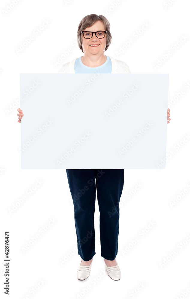 Smiling old lady holding blank whiteboard Smiling old lady holding blank whiteboard