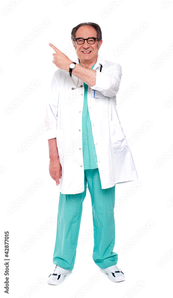 Full length image of doctor indicating up Full length image of doctor indicating up