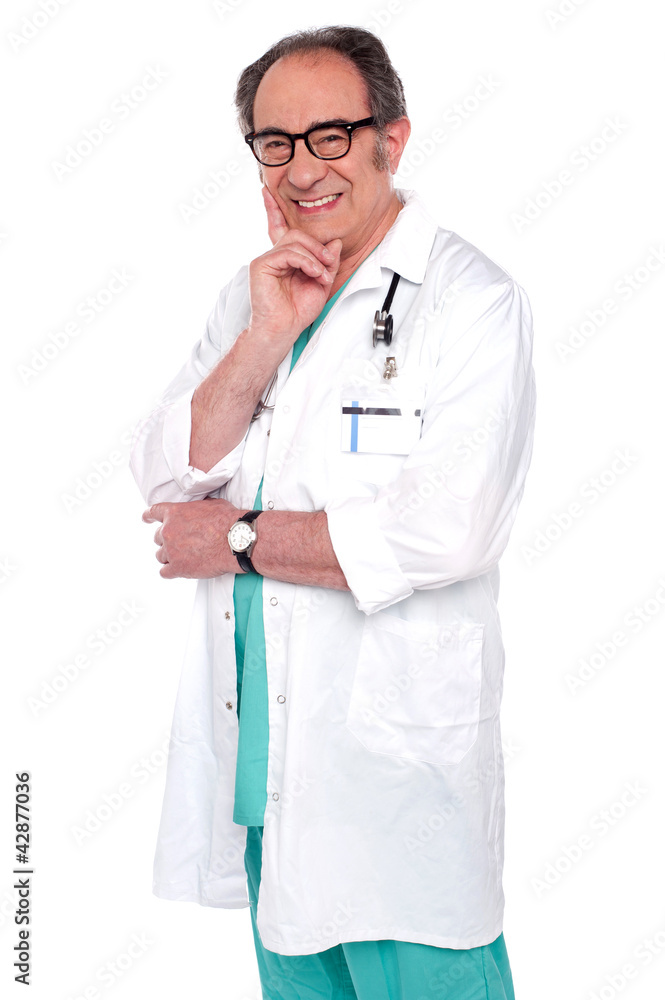 Senior male doctor posing against white Senior male doctor posing against white