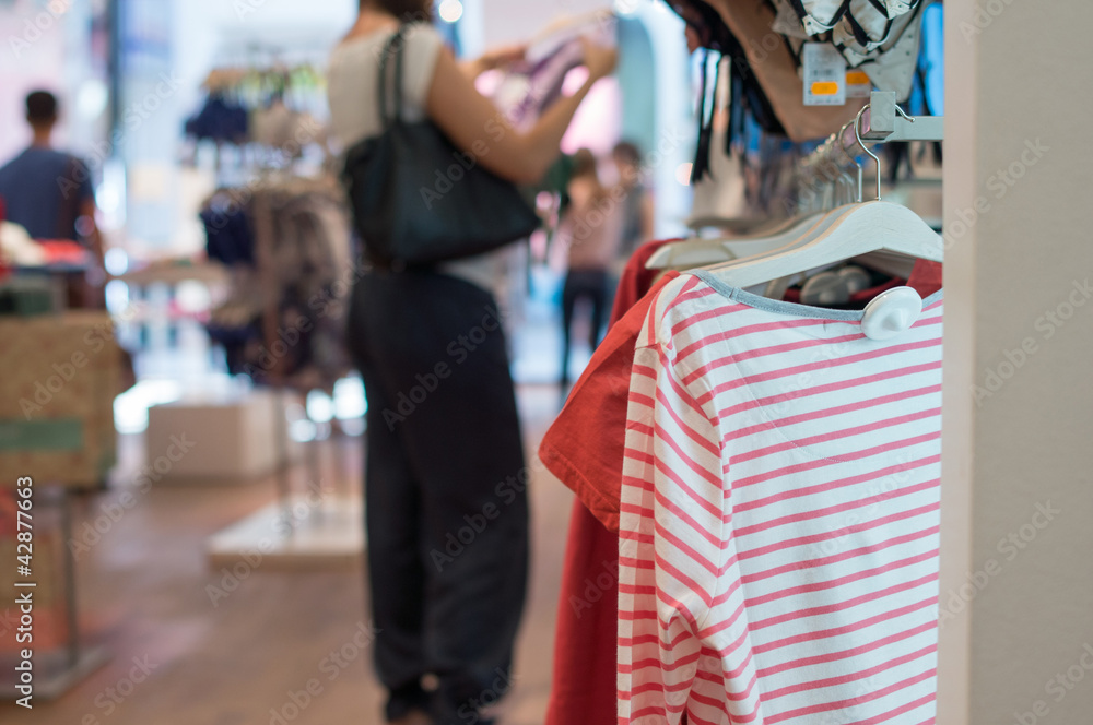 Fototapeta premium T-shirts on stands in shop