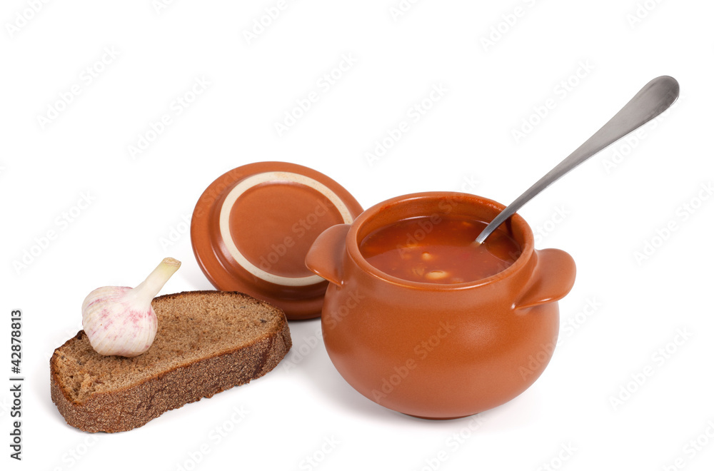 Borsch in clay pot with bread and garlic Borsch in clay pot with bread and garlic