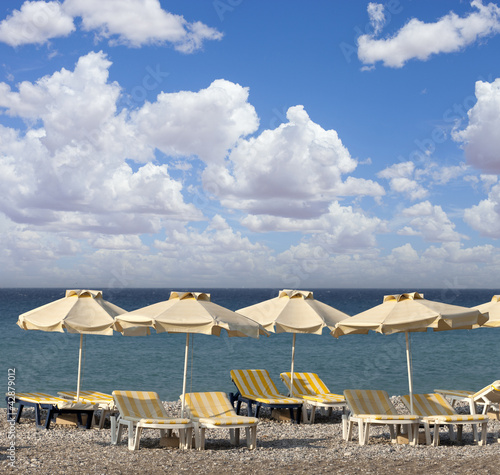 sun umbrella and chairs on a beach © nataiki