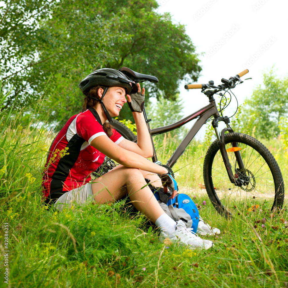 Obraz premium Happy Young Woman riding bicycle outside. Healthy Lifestyle