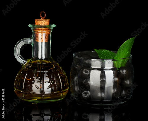Olive oil small decanter isolated on black background